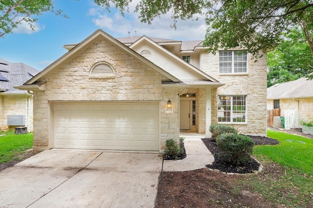 15213 Mallard Green Ln, Austin, TX 78728 - traditional home featuring stone siding, concrete driveway, and an attached garage