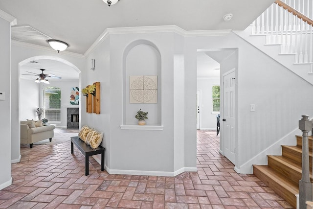 15213 Mallard Green Ln, Austin, TX 78728 - foyer entrance featuring brick flooring, a ceiling fan, stairway, crown molding, and plenty of natural light