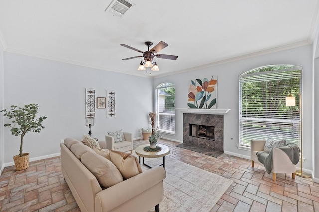 15213 Mallard Green Ln, Austin, TX 78728 - living room with brick flooring, ornamental molding, a premium fireplace, and ceiling fan