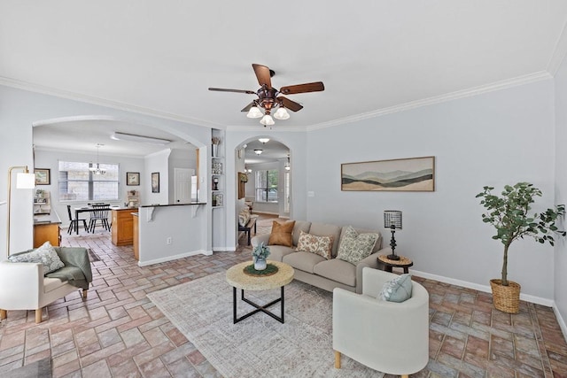 15213 Mallard Green Ln, Austin, TX 78728 - living room with arched walkways, a ceiling fan, crown molding, and brick patterned flooring