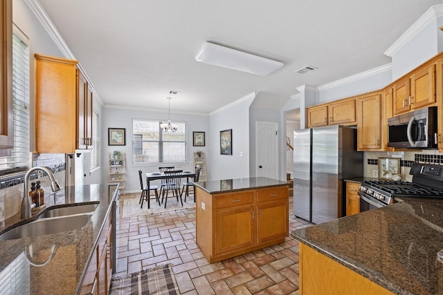 15213 Mallard Green Ln, Austin, TX 78728 - kitchen with appliances with stainless steel finishes, brick flooring, tasteful backsplash, a chandelier, and a center island