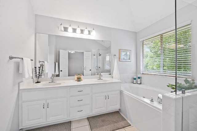 15213 Mallard Green Ln, Austin, TX 78728 - bathroom featuring a stall shower, double vanity, a bath, tile patterned floors, and lofted ceiling