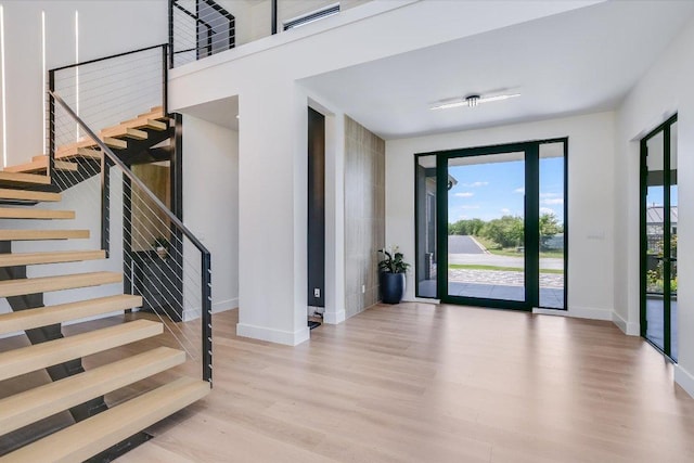1806 Lauren Dr, Spicewood, TX 78669 - entrance foyer with wood finished floors and stairs