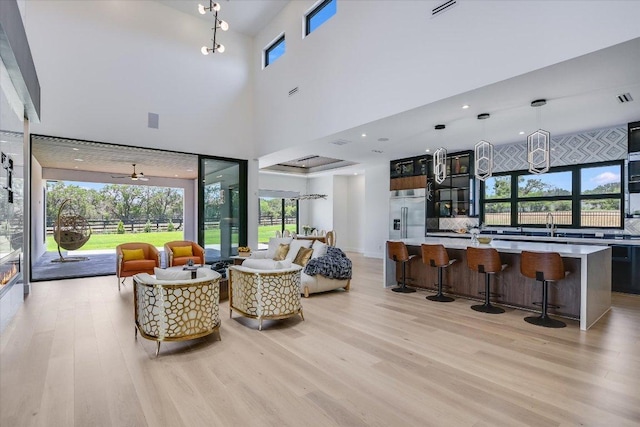 1806 Lauren Dr, Spicewood, TX 78669 - living area with light wood-style floors and a towering ceiling