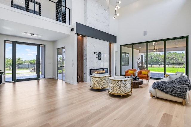 1806 Lauren Dr, Spicewood, TX 78669 - living area featuring a high ceiling, wood finished floors, and a premium fireplace