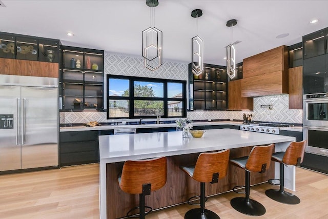 1806 Lauren Dr, Spicewood, TX 78669 - kitchen featuring stainless steel appliances, tasteful backsplash, glass insert cabinets, and light countertops
