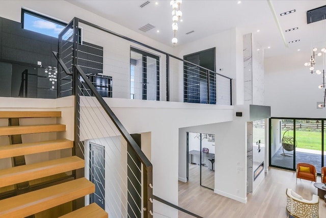 1806 Lauren Dr, Spicewood, TX 78669 - stairs with a towering ceiling and wood finished floors