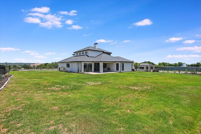 1806 Lauren Dr, Spicewood, TX 78669 - rear view of house with a patio area, a chimney, and a metal roof