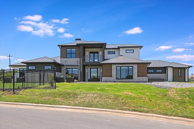 1806 Lauren Dr, Spicewood, TX 78669 - view of front of house featuring a standing seam roof, a metal roof, a balcony, and stone siding