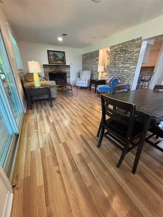 3205 Whites Dr, Austin, TX 78735 - dining room with a fireplace and light wood-style floors