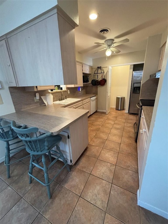 3205 Whites Dr, Austin, TX 78735 - kitchen with stainless steel refrigerator with ice dispenser, decorative backsplash, dishwasher, white cabinets, and ceiling fan