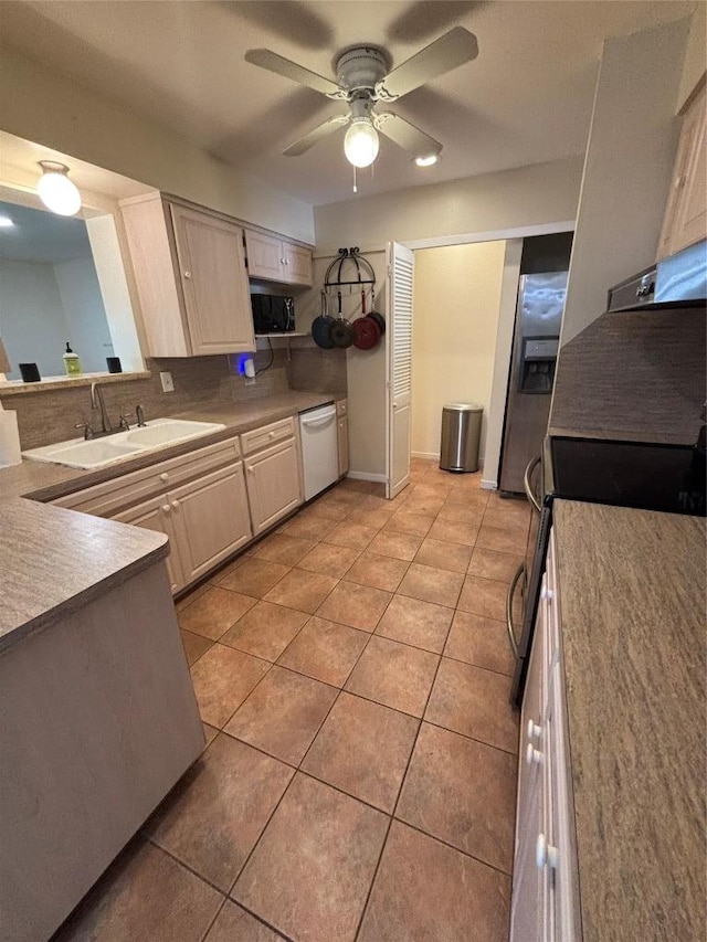 3205 Whites Dr, Austin, TX 78735 - kitchen with appliances with stainless steel finishes, light tile patterned floors, tasteful backsplash, and ceiling fan