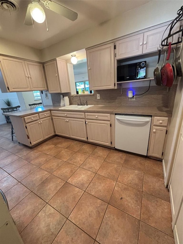 3205 Whites Dr, Austin, TX 78735 - kitchen with dishwasher, black microwave, tasteful backsplash, light tile patterned floors, and a peninsula