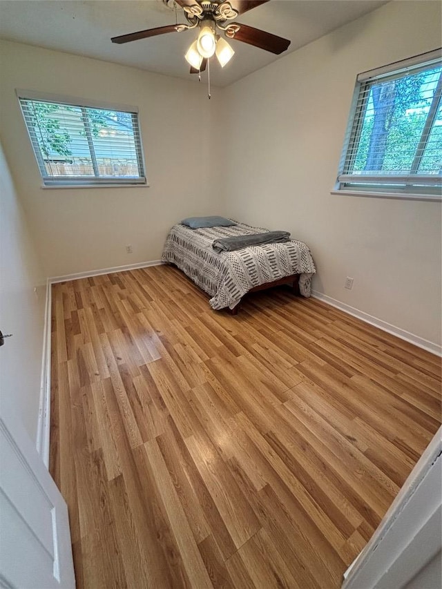 3205 Whites Dr, Austin, TX 78735 - bedroom with multiple windows, light wood finished floors, and a ceiling fan