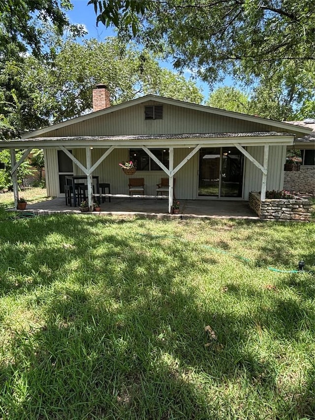 3205 Whites Dr, Austin, TX 78735 - back of property with a chimney, a patio area, and a lawn