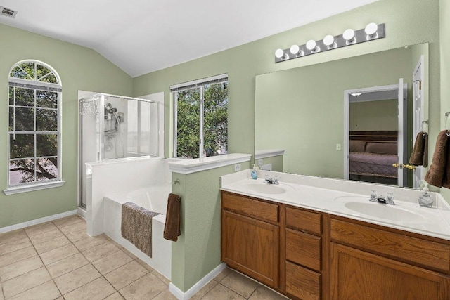 906 Pecos Cv, Leander, TX 78641 - ensuite bathroom with a stall shower, a garden tub, tile patterned floors, double vanity, and vaulted ceiling