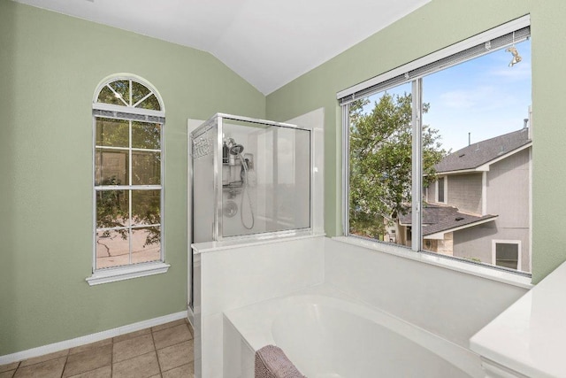 906 Pecos Cv, Leander, TX 78641 - bathroom featuring a shower stall, a garden tub, healthy amount of natural light, vaulted ceiling, and tile patterned floors