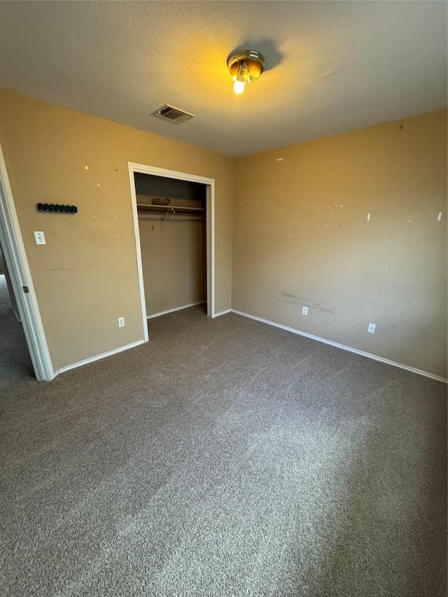 209 Lake Washington Dr, Kyle, TX 78640 - unfurnished bedroom with a closet and carpet floors