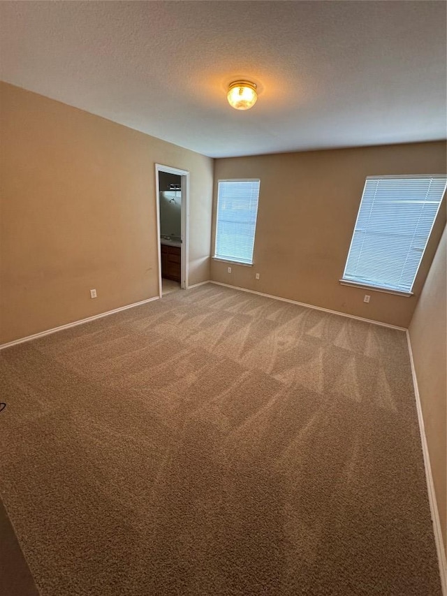 209 Lake Washington Dr, Kyle, TX 78640 - spare room with light colored carpet and a textured ceiling