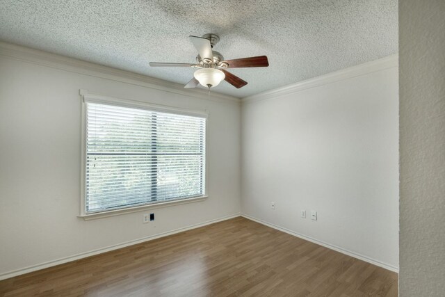 2801 Adelen Ln, Round Rock, TX 78664 - empty room with a textured ceiling, ceiling fan, wood finished floors, and crown molding