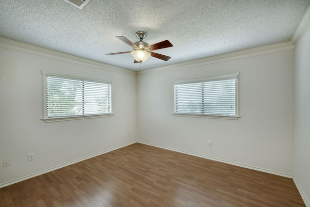 2801 Adelen Ln, Round Rock, TX 78664 - spare room featuring healthy amount of natural light, wood finished floors, a ceiling fan, ornamental molding, and a textured ceiling