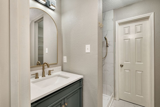 2801 Adelen Ln, Round Rock, TX 78664 - full bathroom featuring a marble finish shower, vanity, a textured wall, and marble look tiles