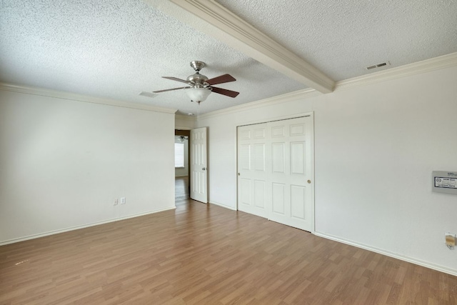 2801 Adelen Ln, Round Rock, TX 78664 - unfurnished bedroom with wood finished floors, ornamental molding, a textured ceiling, a closet, and ceiling fan