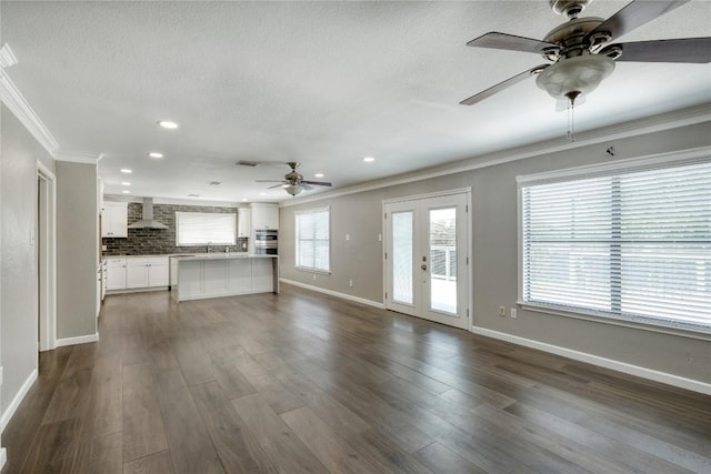 2801 Adelen Ln, Round Rock, TX 78664 - unfurnished living room with a ceiling fan, ornamental molding, recessed lighting, dark wood-type flooring, and a textured ceiling