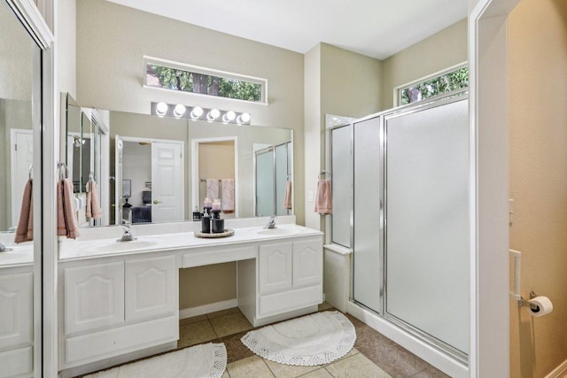 136 Trail Of The Flowers, Georgetown, TX 78633 - bathroom with healthy amount of natural light, tile patterned floors, a shower stall, and double vanity