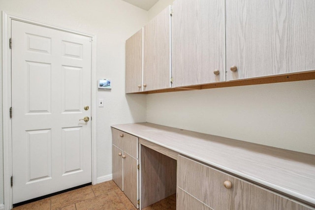 136 Trail Of The Flowers, Georgetown, TX 78633 - laundry area with baseboards and a desk