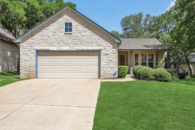 136 Trail Of The Flowers, Georgetown, TX 78633 - view of front of house with stone siding, a front lawn, concrete driveway, and an attached garage