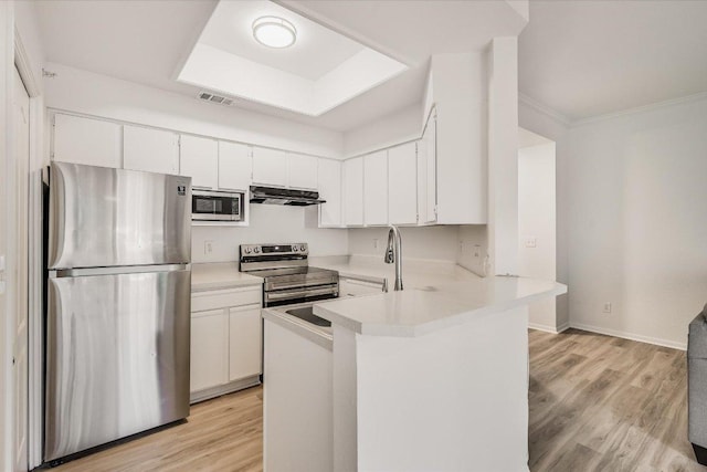 6000 Shepherd Mountain Cv Unit 1805, Austin, TX 78730 - kitchen featuring appliances with stainless steel finishes, exhaust hood, light countertops, a peninsula, and white cabinets