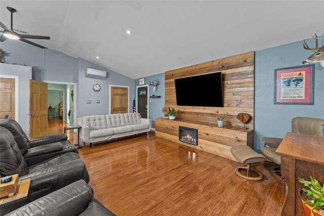 1200 County Road 149, Georgetown, TX 78626 - living area with a wall mounted air conditioner, ceiling fan, wood finished floors, and high vaulted ceiling