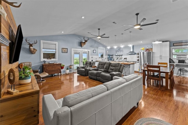 1200 County Road 149, Georgetown, TX 78626 - living area with a ceiling fan, vaulted ceiling, wood finished floors, and healthy amount of natural light