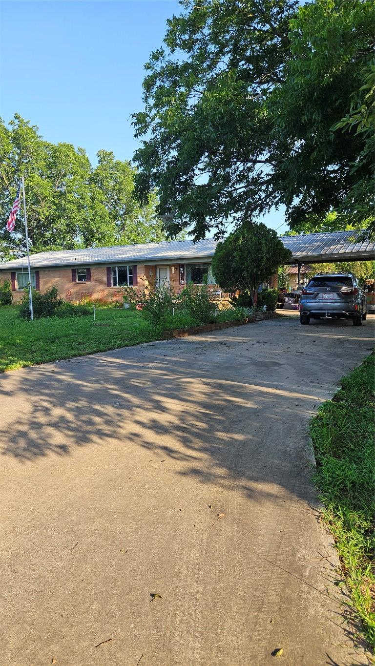 3222 County Road 2403rd Rd, Winnsboro, TX 75494 - ranch-style house featuring asphalt driveway and a detached carport