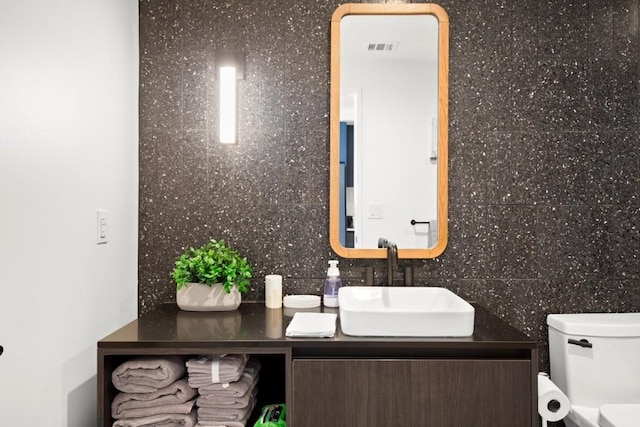48 E Ave Unit 2707, Austin, TX 78701 - bathroom featuring double vanity and tasteful backsplash
