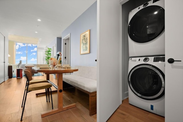 48 E Ave Unit 2707, Austin, TX 78701 - washroom featuring stacked washer and clothes dryer, wood finished floors, and recessed lighting