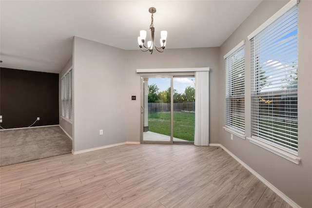 101 Crimson Ln, Kyle, TX 78640 - spare room featuring a chandelier and light wood-type flooring