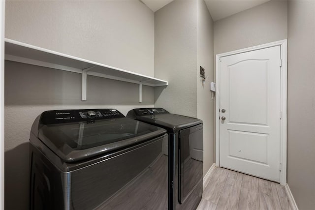 101 Crimson Ln, Kyle, TX 78640 - laundry area featuring light wood-type flooring and washer and clothes dryer