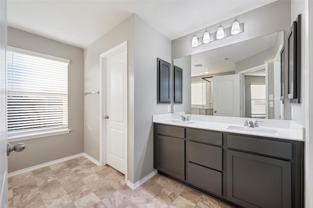 101 Crimson Ln, Kyle, TX 78640 - full bathroom with double vanity and baseboards