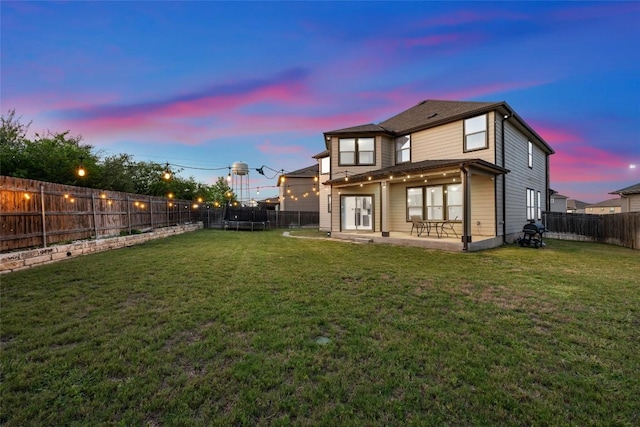 101 Crimson Ln, Kyle, TX 78640 - rear view of property with a trampoline, a fenced backyard, and a patio area