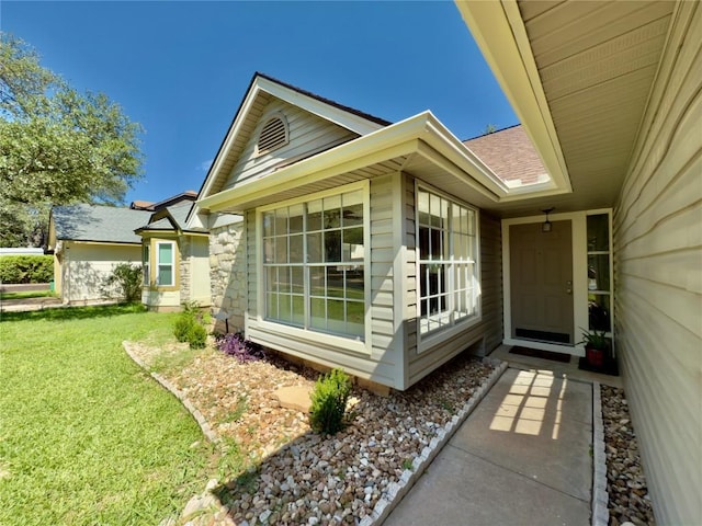6400 Jennings Dr, Austin, TX 78727 - entrance to property with a lawn, a shingled roof, and stone siding