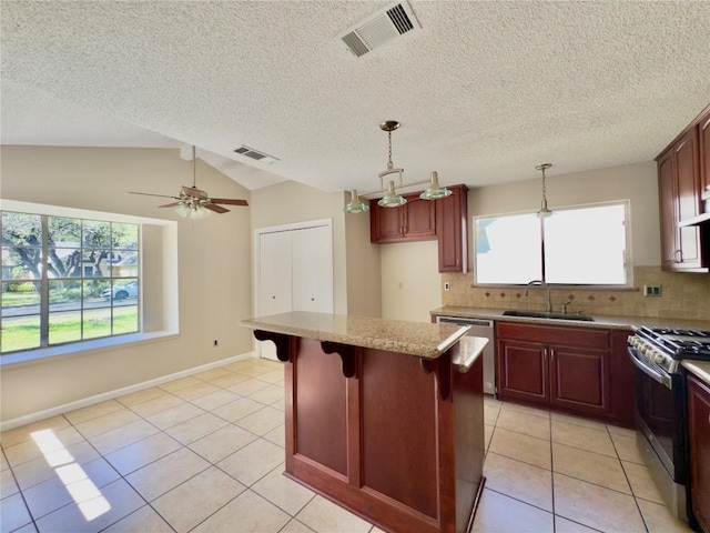 6400 Jennings Dr, Austin, TX 78727 - kitchen with stainless steel appliances, light tile patterned floors, tasteful backsplash, dark brown cabinets, and lofted ceiling
