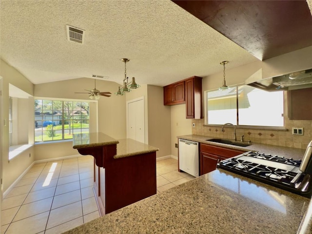 6400 Jennings Dr, Austin, TX 78727 - kitchen featuring dishwasher, light tile patterned floors, decorative backsplash, plenty of natural light, and vaulted ceiling