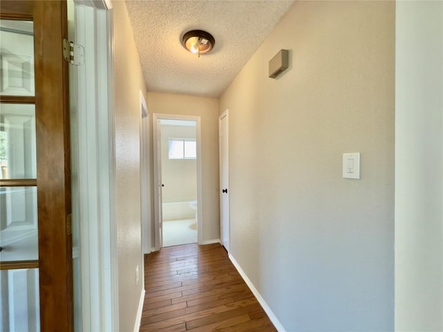6400 Jennings Dr, Austin, TX 78727 - hall featuring a textured ceiling and wood-type flooring