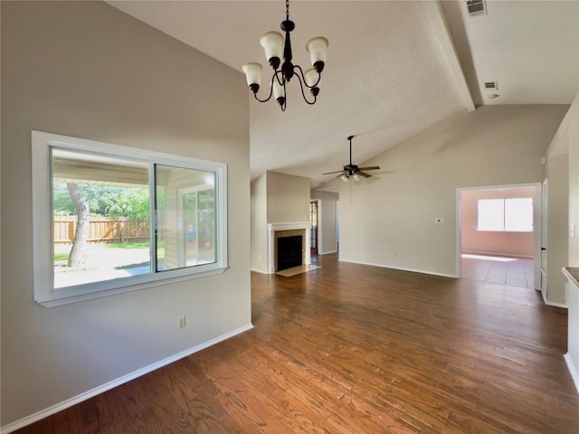 6400 Jennings Dr, Austin, TX 78727 - unfurnished living room with a chandelier, healthy amount of natural light, a fireplace with flush hearth, wood finished floors, and high vaulted ceiling