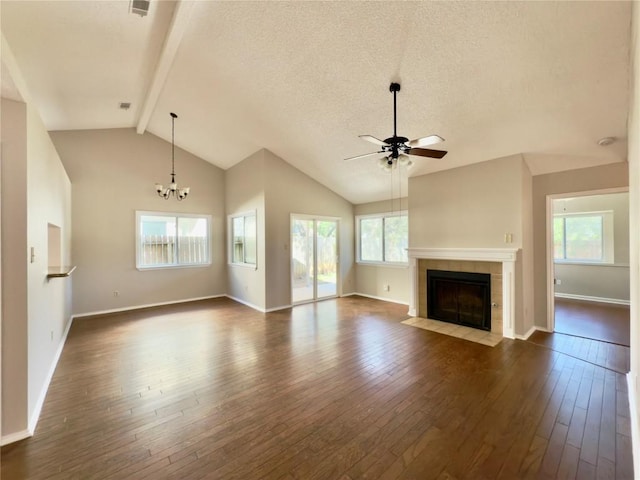 6400 Jennings Dr, Austin, TX 78727 - unfurnished living room with dark wood-type flooring, a ceiling fan, beamed ceiling, a fireplace, and a chandelier