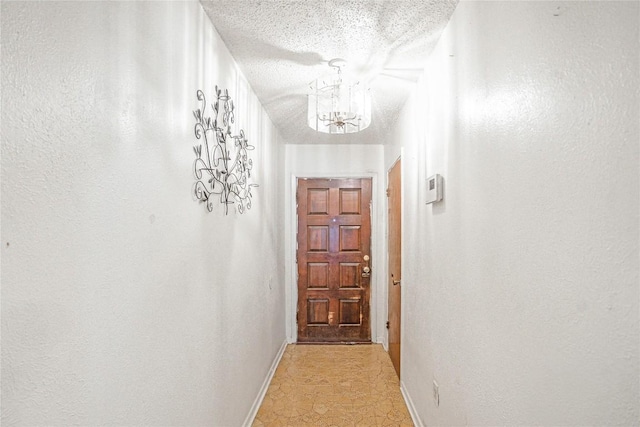 906 Lynn Ln, Copperas Cove, TX 76522 - corridor featuring a chandelier, a textured ceiling, and light flooring