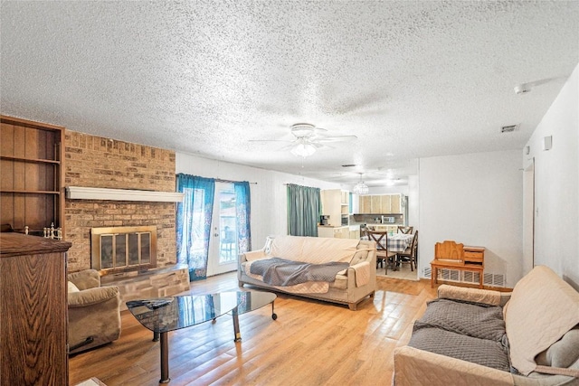 906 Lynn Ln, Copperas Cove, TX 76522 - living area with ceiling fan, a textured ceiling, wood finished floors, and a fireplace
