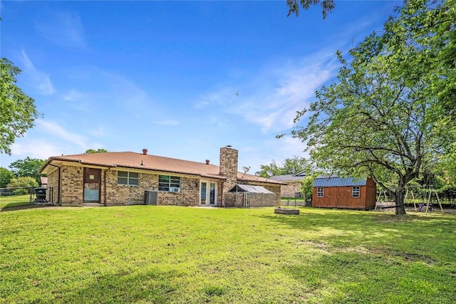 906 Lynn Ln, Copperas Cove, TX 76522 - back of house featuring a shed, a fenced backyard, a chimney, and brick siding